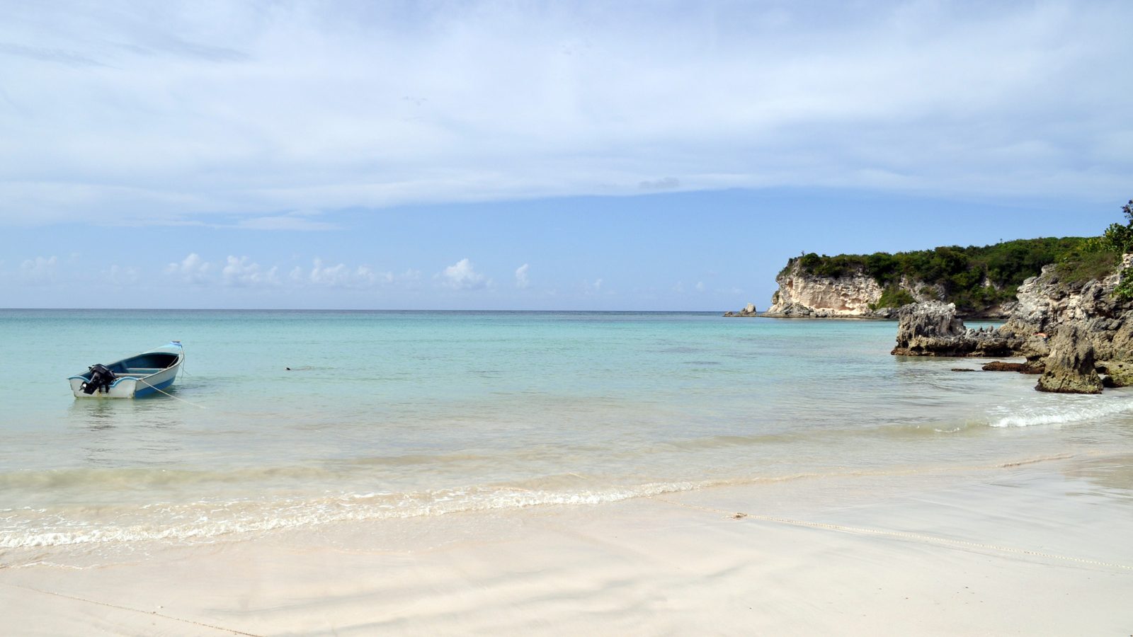Rugged Macao Beach in Punta Cana with surfers and cliffs