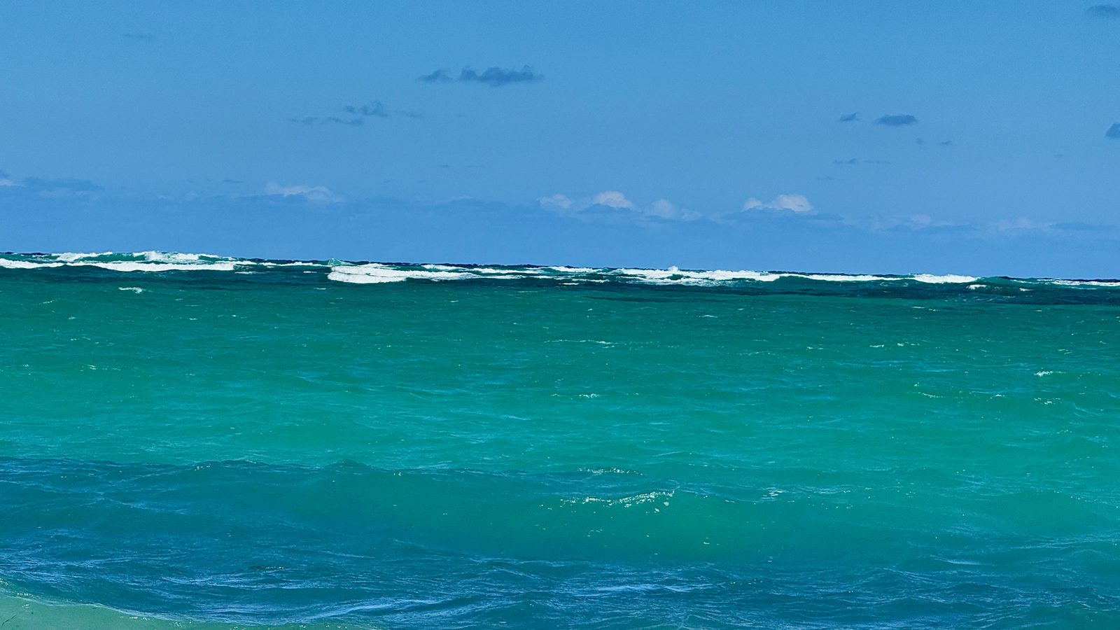 Colorful fishing boats on El Cortecito Beach with village vibe
